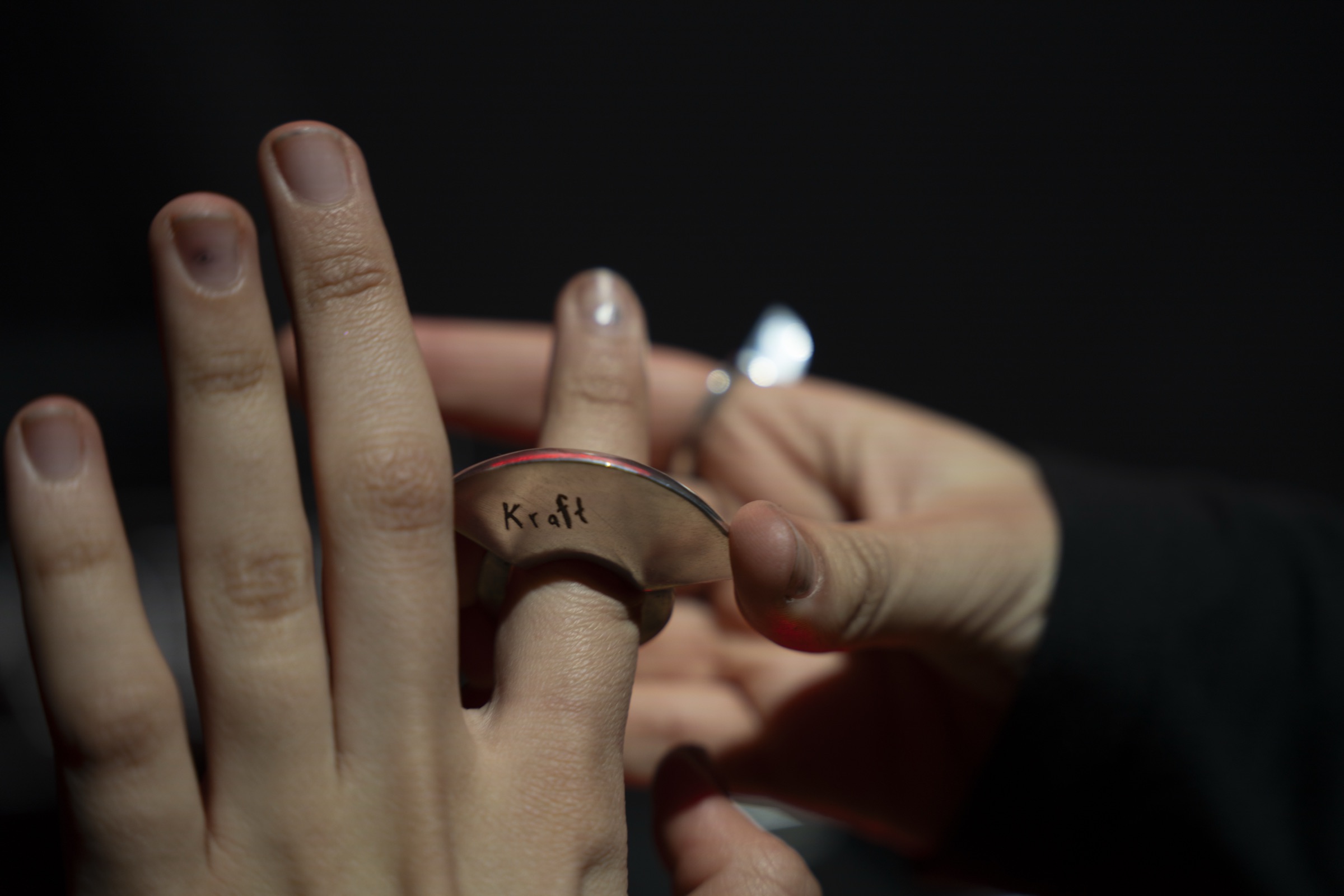 The KRAFT ring passed between two hands