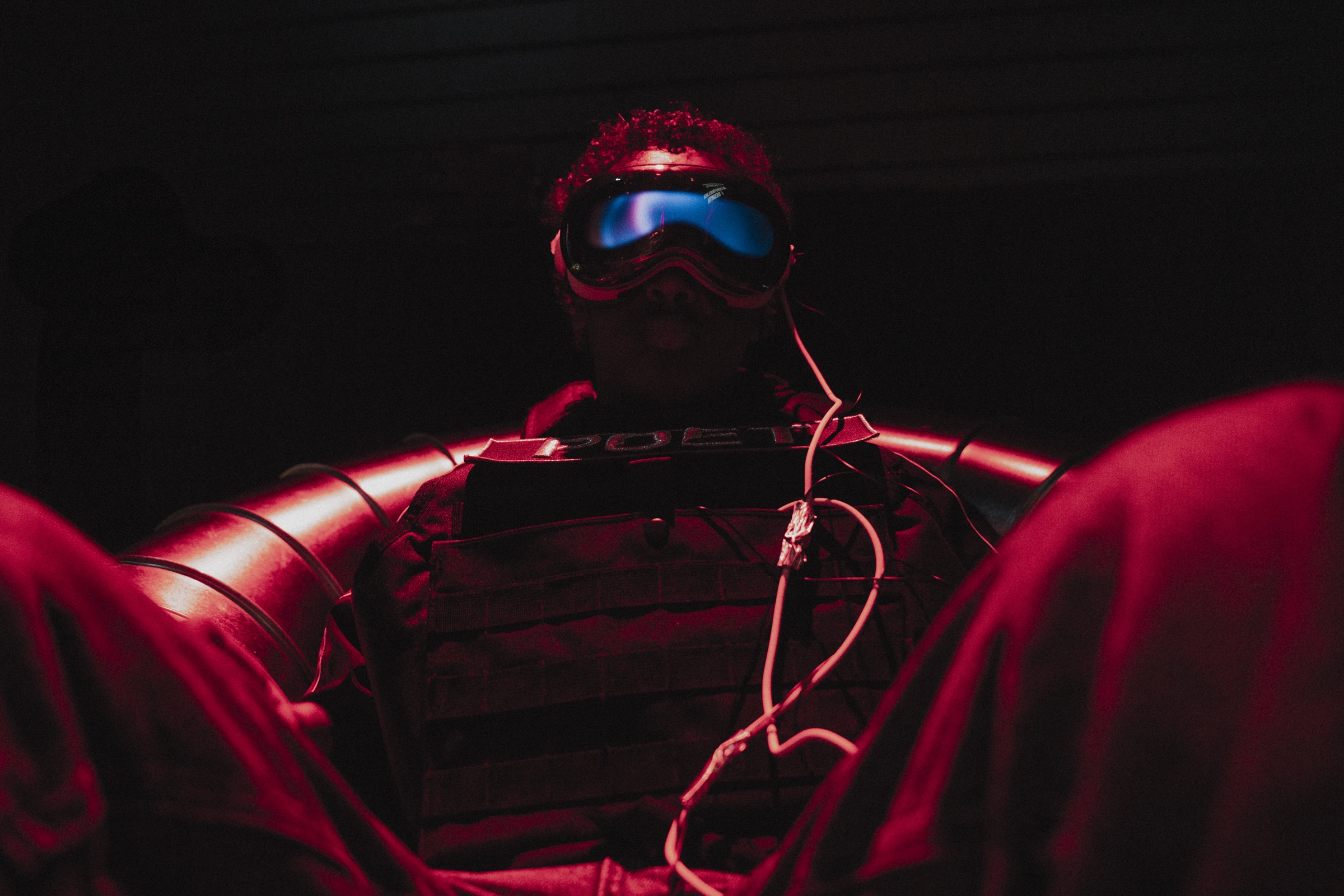 Visitor in headset bathed in red light